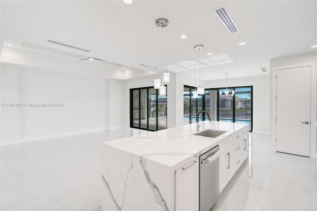 kitchen featuring sink, dishwasher, white cabinetry, hanging light fixtures, and an island with sink