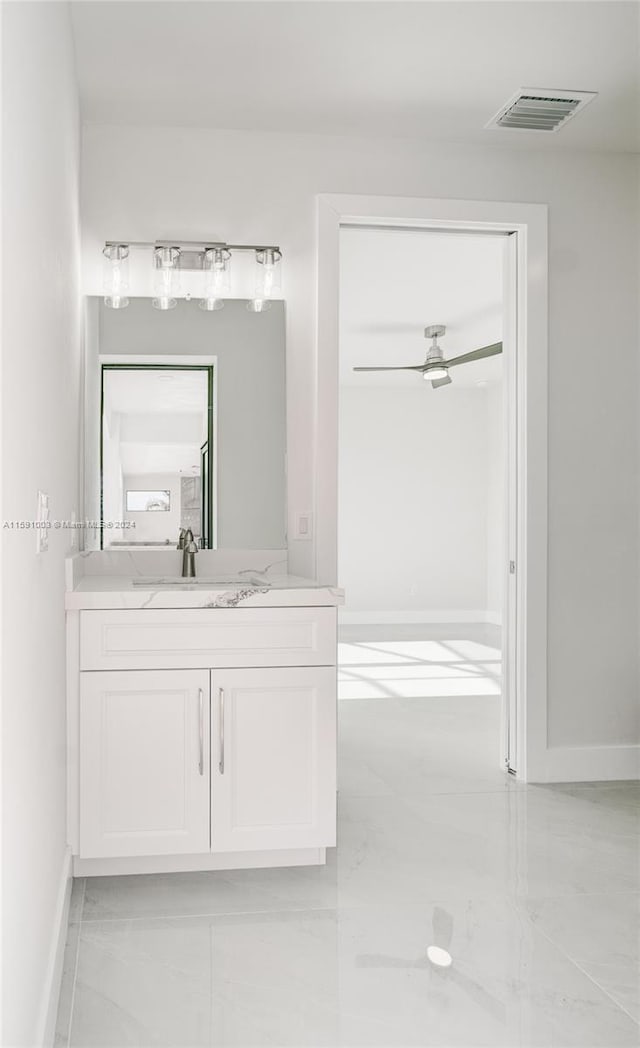 bathroom with ceiling fan, tile patterned floors, and vanity