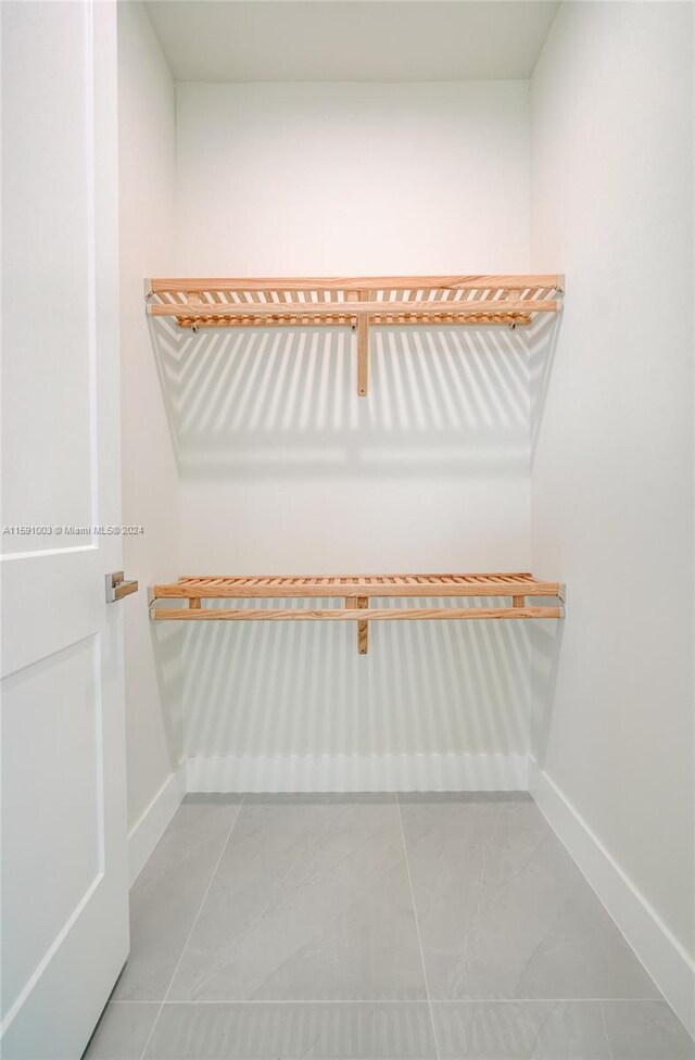 spacious closet with tile patterned floors