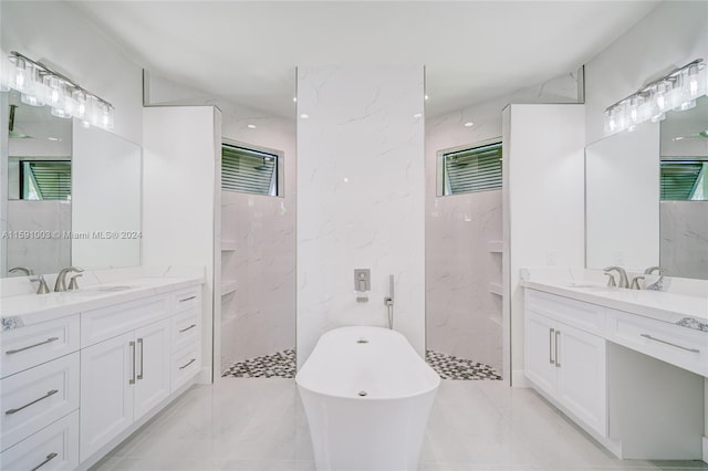 bathroom with vanity, shower with separate bathtub, and tile walls