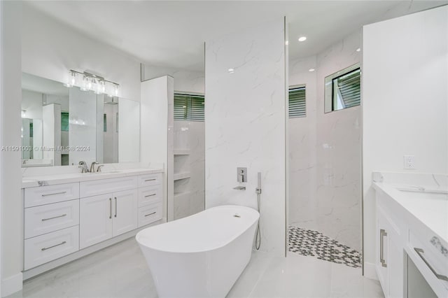 bathroom featuring vanity and shower with separate bathtub