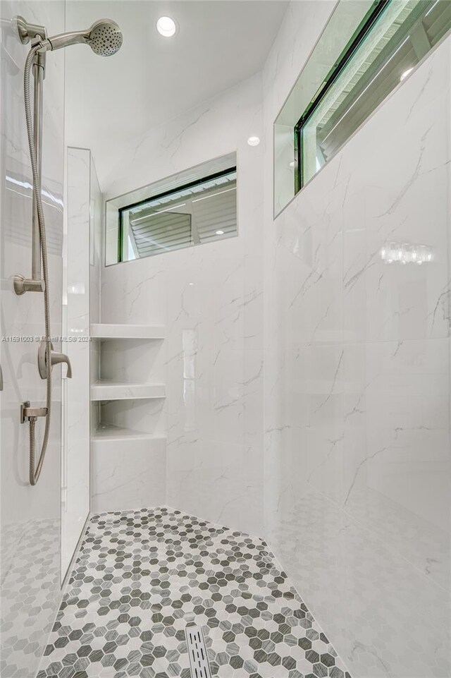 bathroom with a tile shower