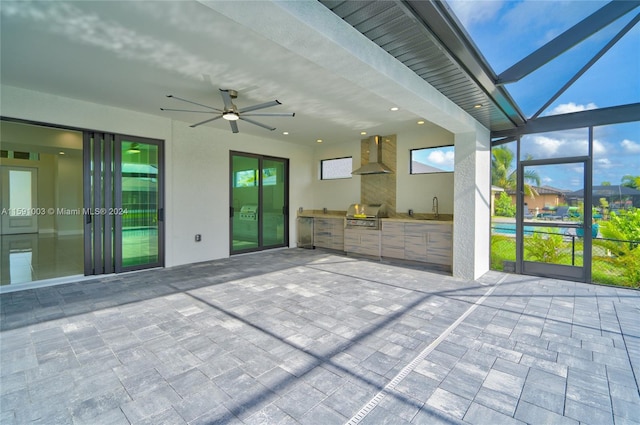 unfurnished sunroom with ceiling fan and sink