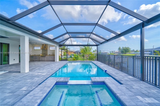 view of swimming pool featuring ceiling fan, a patio, and a lanai