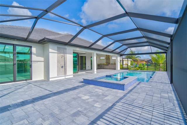 view of pool with a lanai, a patio, and an in ground hot tub