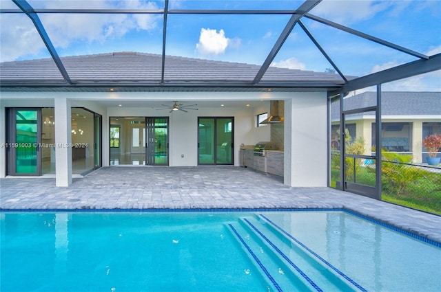 back of house featuring ceiling fan, glass enclosure, and a patio area