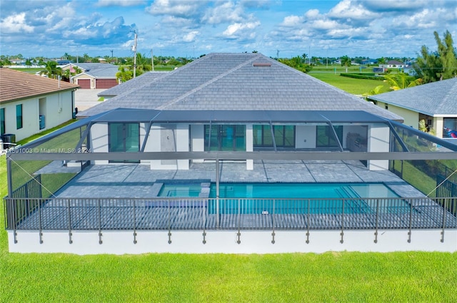 back of house with a lawn and a fenced in pool