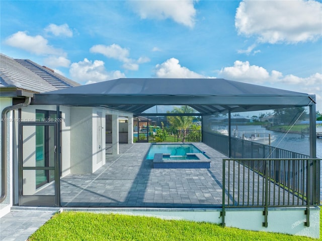 view of pool with an in ground hot tub, a lanai, and a patio