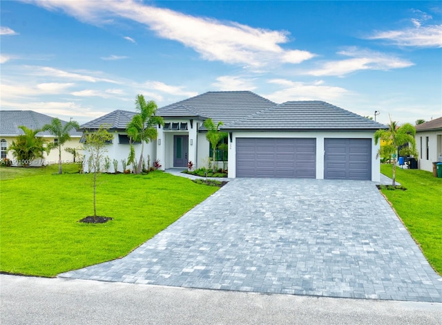 view of front of property with a front lawn and a garage