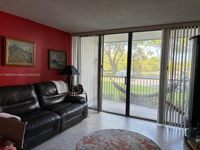 living room with light tile patterned floors, a healthy amount of sunlight, and a textured ceiling