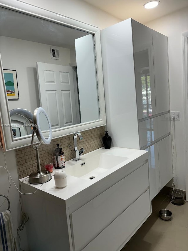 bathroom featuring vanity and decorative backsplash