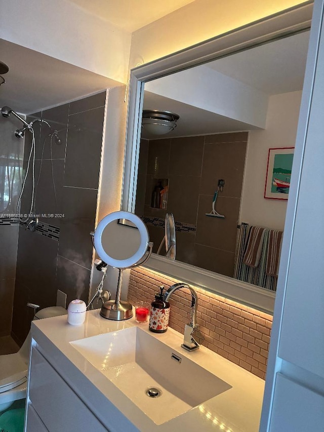 bathroom featuring backsplash, vanity, and tiled shower