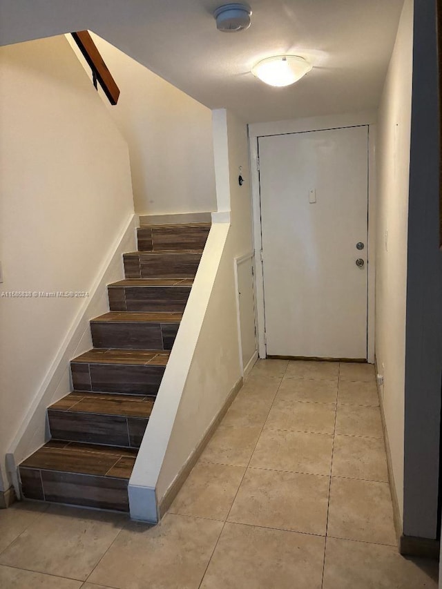 staircase featuring tile patterned floors