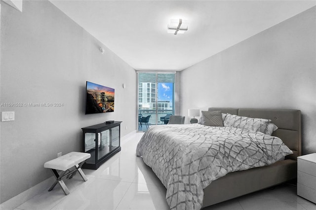 tiled bedroom with floor to ceiling windows and access to outside