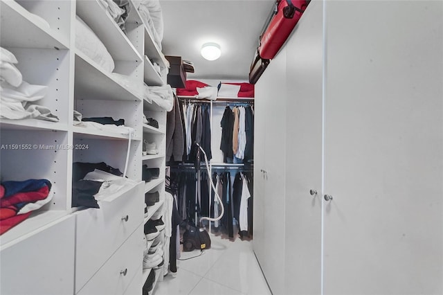 walk in closet featuring light tile patterned flooring