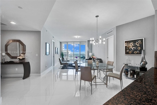 dining room with a wall of windows and a notable chandelier