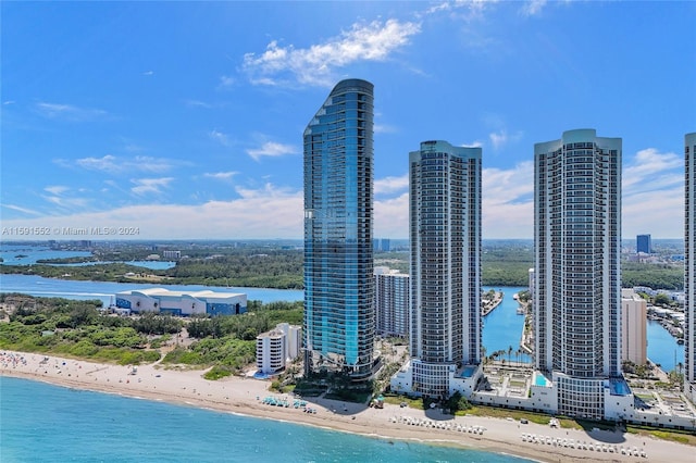 birds eye view of property with a view of the beach and a water view