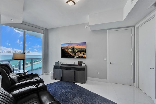 tiled living room with floor to ceiling windows and a water view