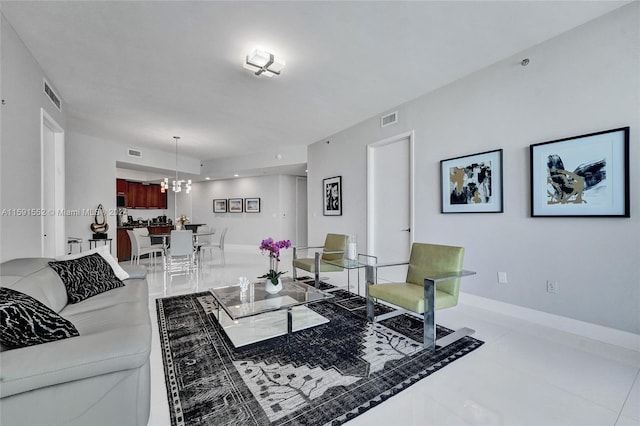 tiled living room featuring a chandelier