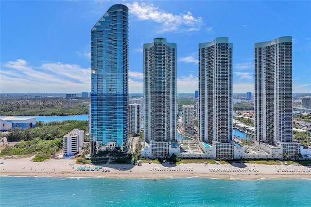 exterior space featuring a beach view, a water view, and cooling unit