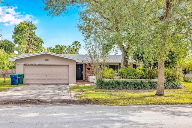 ranch-style home with a garage and a front lawn