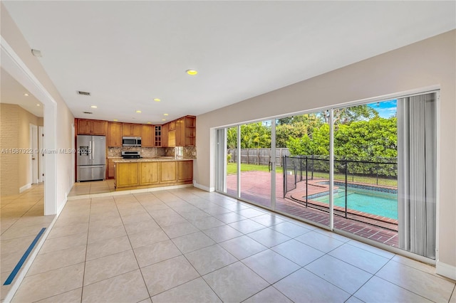 unfurnished living room with light tile patterned floors