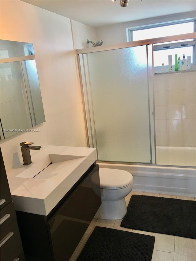 full bathroom featuring tile flooring, toilet, and vanity