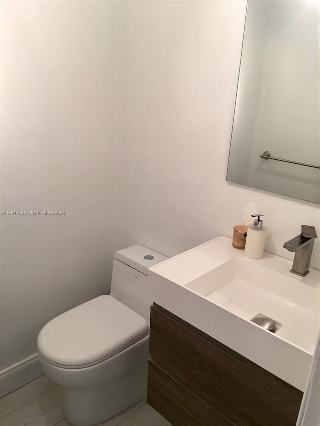 bathroom featuring toilet and vanity