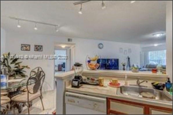 kitchen with dishwasher, track lighting, and sink