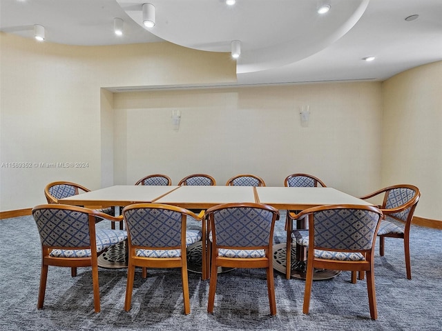 dining space featuring dark carpet