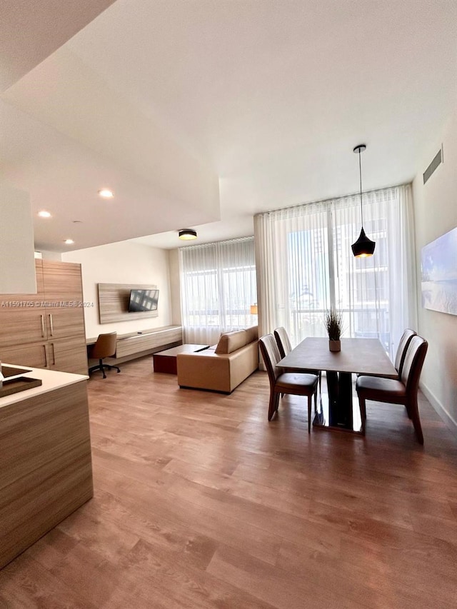 dining space with hardwood / wood-style flooring