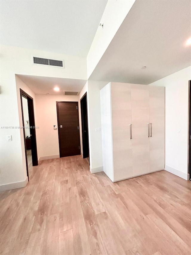 hallway with hardwood / wood-style floors