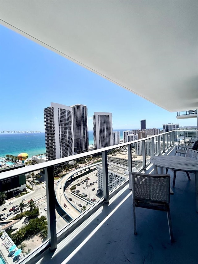 balcony featuring a water view and a view of city