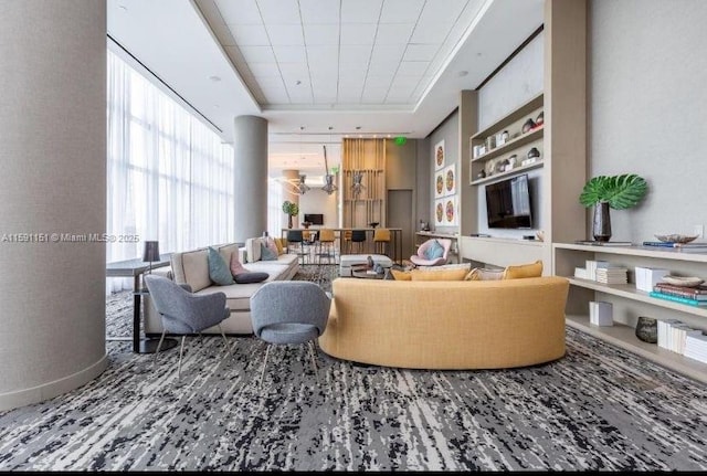 living area featuring a tray ceiling