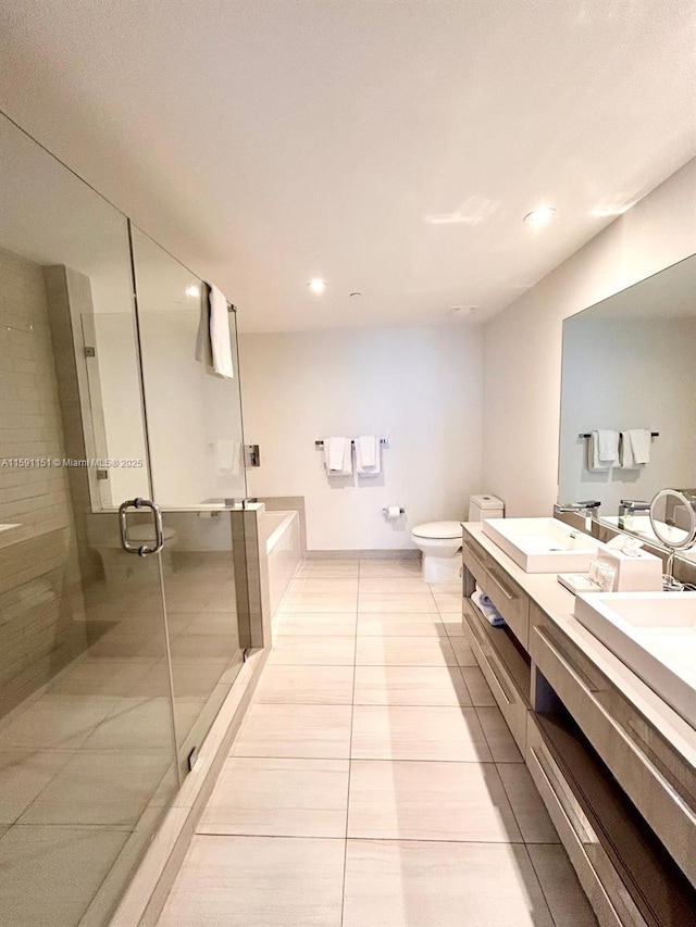 full bathroom featuring a garden tub, toilet, tile patterned floors, double vanity, and a stall shower