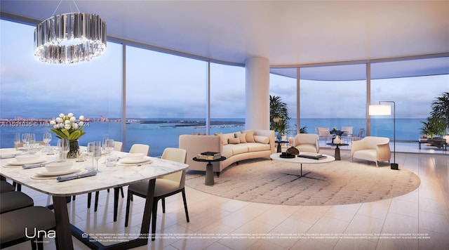 living room with a healthy amount of sunlight, a chandelier, a wall of windows, and a water view