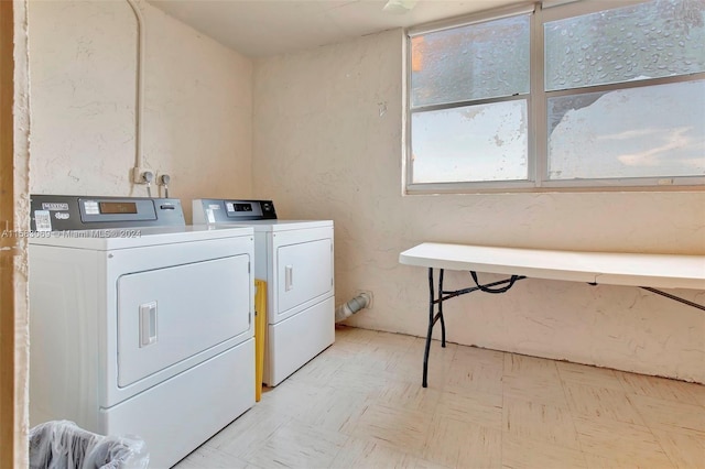 shared laundry area with independent washer and dryer and light floors