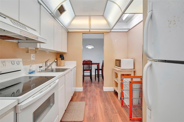 kitchen with white cabinetry, light hardwood / wood-style flooring, white appliances, premium range hood, and sink