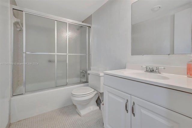 full bathroom featuring tile floors, shower / bath combination with glass door, large vanity, and toilet