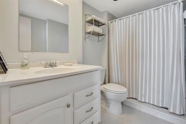 bathroom featuring toilet, tile floors, and large vanity