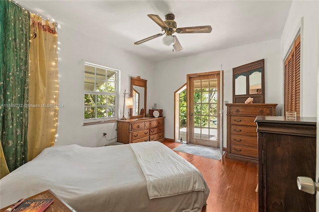 bedroom featuring hardwood / wood-style floors, a closet, ceiling fan, and access to exterior