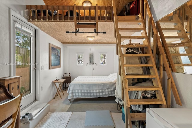 bedroom with refrigerator and concrete flooring