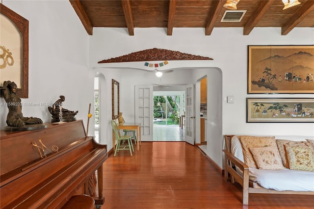 interior space featuring beamed ceiling, wood ceiling, and hardwood / wood-style floors