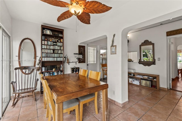 tiled dining area featuring ceiling fan