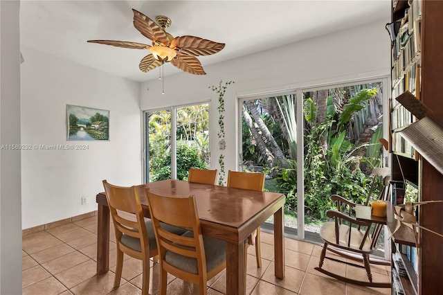 tiled dining space featuring ceiling fan