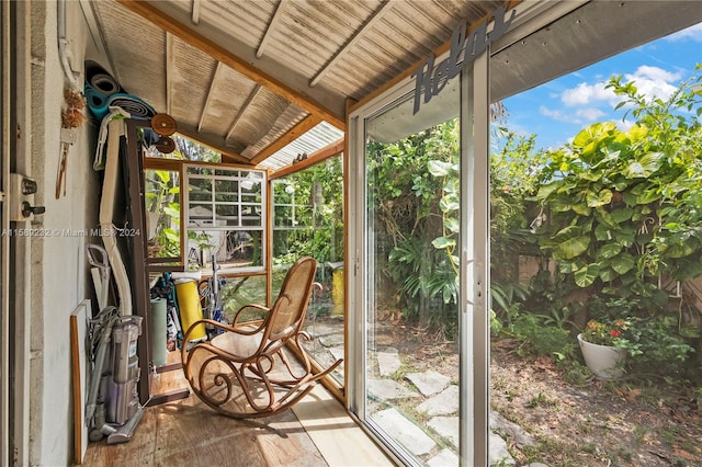 unfurnished sunroom featuring lofted ceiling