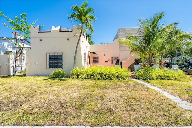 rear view of property featuring a yard