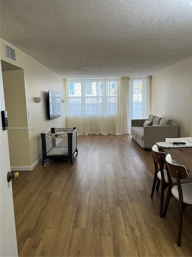 corridor featuring hardwood / wood-style flooring and a textured ceiling