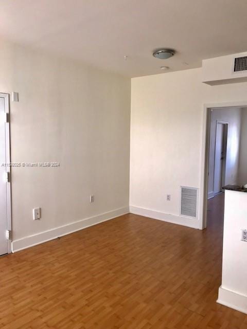 spare room featuring dark hardwood / wood-style floors