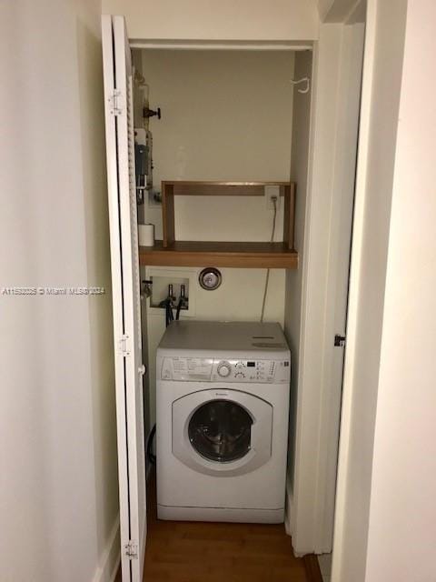 washroom featuring dark wood-type flooring and washer / clothes dryer